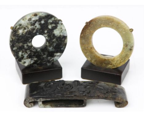 Chinese jade mottled black and grey bi-disc, one side carved with scrolling decoration, the other with four Chinese character