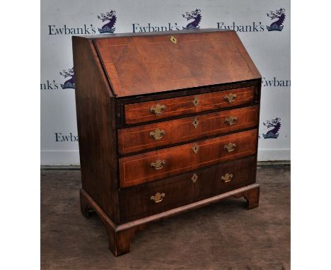 George III walnut bureau, with fall flap enclosing an arrangement of cupboards and pigeon holes, above four graduated drawers
