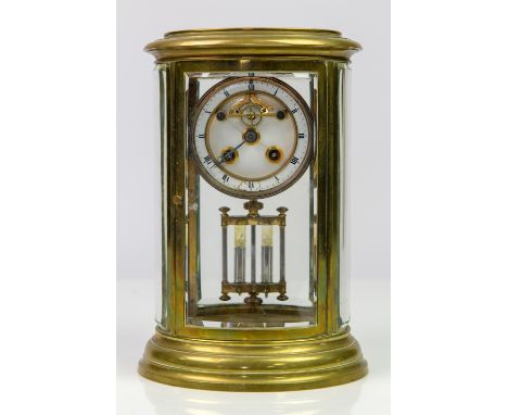 French brass mantel clock, 19th Century, white enamel dial with Roman chapter ring, exposed escapement, mercury pendulum and 