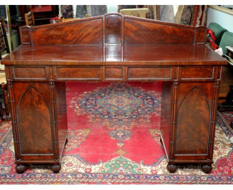 Regency mahogany sideboard, the top with triangular architectural back, above plain rectangular top, with single wine drawer,