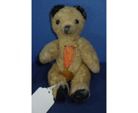 Early Continental wood filled jointed Sooty bear with boot button eyes, rexine pads and wool stitched nose wearing a commemor