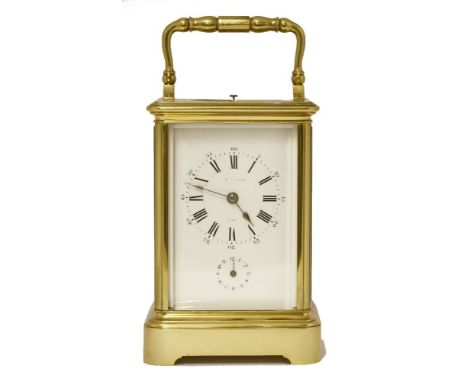 An enormous French brass carriage clock, with repeat and alarm mechanisms and a silvered platform escapement, the white dial 