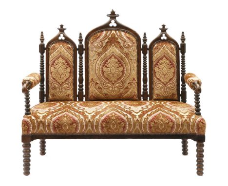 A French Gothic walnut three-seater settee,19th century, the back with three lancet-shaped panels on bobbin turned supports,1