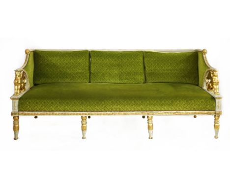 A Swedish Empire sofa,decorated in relief with stylised foliate designs, with lion masks and a carved gilded sphinx supportin
