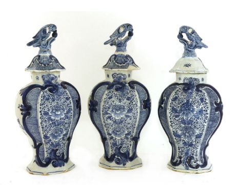A garniture of three blue and white Dutch delft vases and covers,mid-18th century, in the manner of Johannes van Duyn, each d