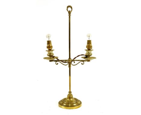A brass student's lamp c.1820, with two candleholders on an adjustable stem, converted for electricity,53cm high, weighted ba