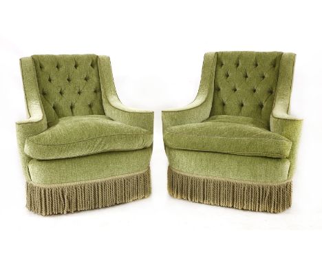 A pair of Howard Chair Ltd. green velvet armchairs, each with button backs and a bullion frieze, on brass castors, stamped 'H