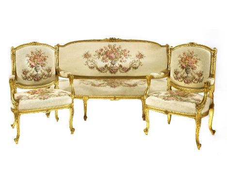 A Louis XVI-style sofa,19th century, the shaped top rail carved with flower heads over an upholstered back and shaped seat on