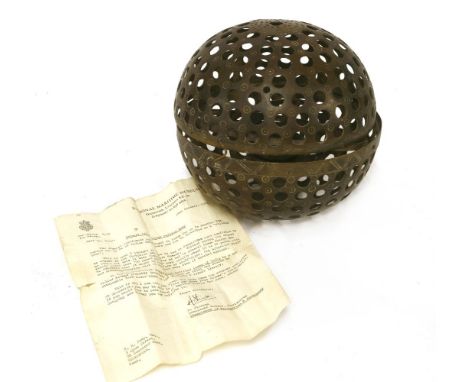 An Indian rolling lamp,20th century, with a pierced brass spherical body and interior gimbal, together with an accompanying l
