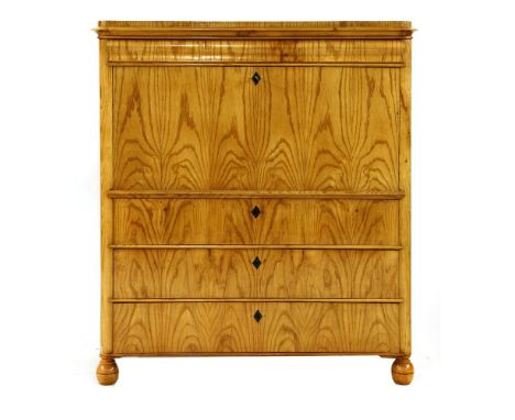 A Biedermeier ash and satin birch secrétaire à abattant, the rounded rectangular top with a shaped frieze, with an hinged fal