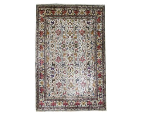 A large cream ground Tabriz carpet,20th century, the central field decorated with a stylised foliate design, within a multipl