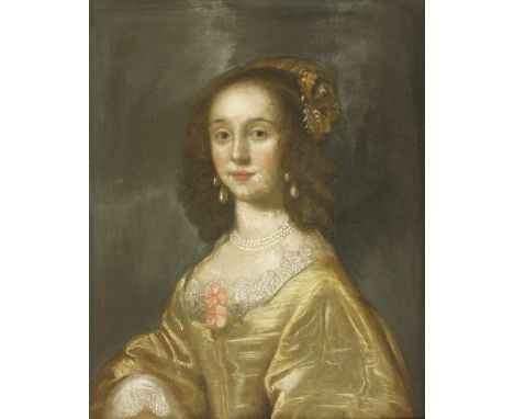 Follower of Sir Anthony van DyckPORTRAIT OF A YOUNG LADY, HALF LENGTH, IN A YELLOW DRESS AND EMBROIDERED HEADDRESS Oil on can