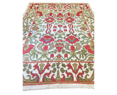 OUSHAK CARPET, 317cm x 240cm, of vines and palmettes in ruby and sage, on natural shade field.