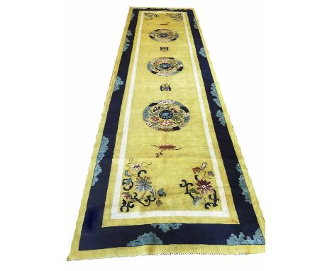 PEKING RUNNER, 430cm x 123cm, famille jaune with repeat disc medallions, with sapphire border.