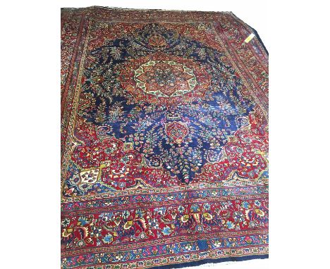 FINE TABRIZ PERSIAN CARPET, 384cm x 285cm, of ivory and ruby rosette medallion on sapphire field within corresponding spandre