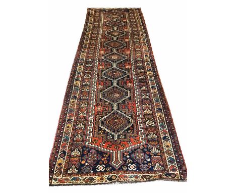 ANTIQUE SHIRAZ RUNNER, 368cm x 124cm, of a pole medallion on sapphire field.