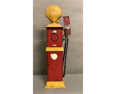 A metal painted model of a vintage shell petrol pump 