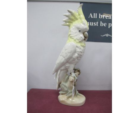 Royal Dux Ceramic Parrot, in yellow and pastel tones, perched on naturalistic base, pink triangular applied plaque and stampe