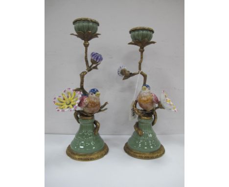 A Pair of Ceramic and Gilt Metal Candlesticks, each as an exotic bird by large flower, multicoloured, on circular base, 28cm 