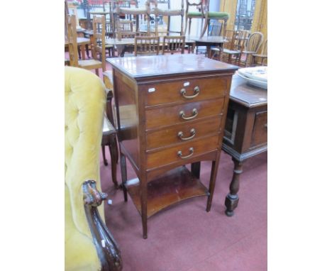 An Early XX Century Mahogany Music Cabinet, with four fall front drawer, under shelf on tapering legs, bearing retailers labe