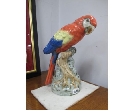 Royal Dux Ceramic Macaw Parrot, on naturalistic base, applied pink triangular plaque and stamped 24500.