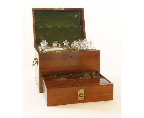 A George III mahogany apothecary's cabinet,the lift-up lid enclosing a fitted interior with bottles and stoppers, the base dr