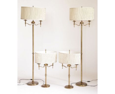 A set of four slender brass lamp standards,20th century, on circular bases,160cm high, anda pair of matching table lamps,78cm