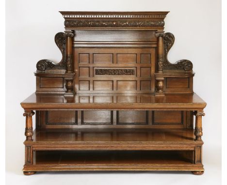 A Victorian oak three-tier buffet,the raised back with carved Renaissance Revival decoration, supported on two turned and car