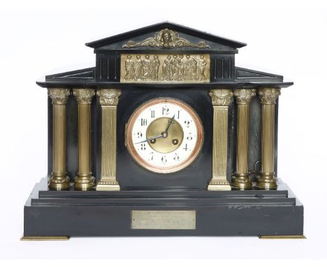 An Edwardian black marble mantel clock,with classical brass mounts and columns and an enamel dial, the movement striking on a