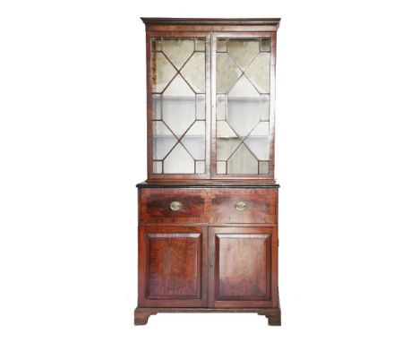 A George lll mahogany secretaire bookcase,having a dentil cornice over two astragal doors, a secretaire drawer fitted with sh