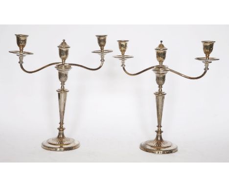 A pair of close-plated three-light candelabra,each on a circular base, rising to a baluster stem and a spool-shaped sconce,41