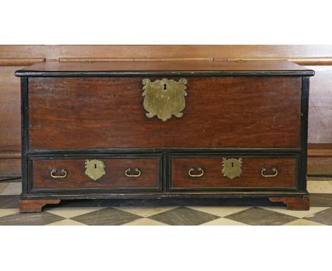 A Portuguese colonial mahogany and ebonised banded chest,early 19th century, the rising lid decorated with a pair of shaped c