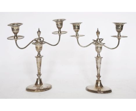 A pair of sheet silver two-light table candelabra,Sheffield, 1834,each on a circular spreading base rising to a baluster stem