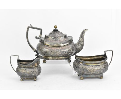 A George III silver three piece tea set, with rubbed hallmarks, comprising a teapot, twin-handled sugar bowl and milk jug, ea