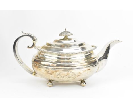 A George III silver teapot by Solomon Hougham, Solomon Royes & John East Dix, London 1818, rounded rectangular form with scro
