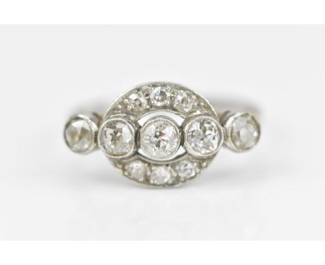 An Art Deco white metal and diamond dress ring, set with row of five similar sized bezel set old cut diamonds, approx 0.2ct e