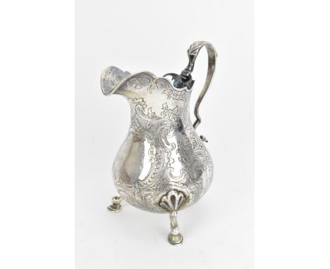 An early Victorian silver milk jug by Thomas Hughes Headland, London 1843, of baluster design with engraved  architectural st