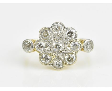 An Art Deco 18ct yellow gold, platinum and diamond daisy ring, the nine central old mine cut stones in a floral cluster flank