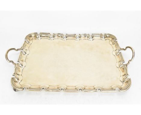 An Edwardian silver twin-handled tray by Harrison Brothers &amp; Howson, London 1902, of rectangular form with moulded border