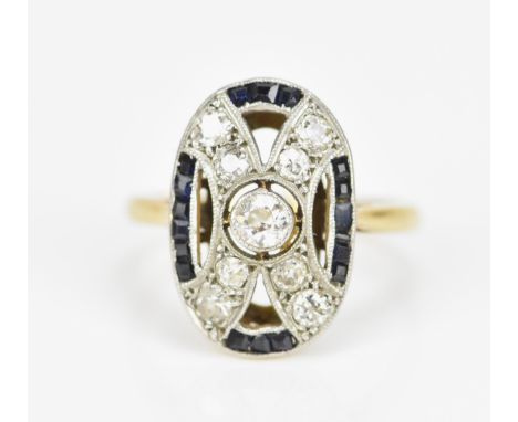 An Art Deco blue sapphire and diamond dress ring, of oval form with central bezel set old cut diamond approx 0.2 ct, with eig