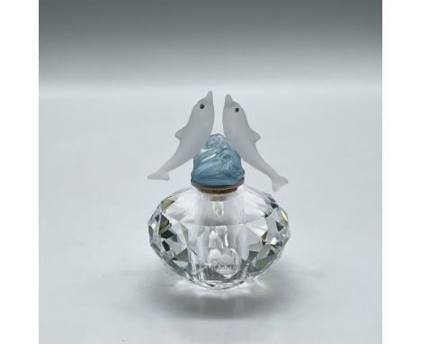 Round cut crystal perfume bottle with blue crystal stopper adorned on each side by dolphins. Swarovski backstamp. 265896. Thi