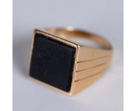 Yellow gold ring set with a square onyx stone which is matte with a distressed appearance. The ring is marked 14k 585 inside.