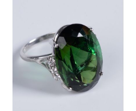 Platinum ring set with an oval faceted green tourmaline stone weighing approximately 26.5cts and measuring 23mm x 16mm x 11.8