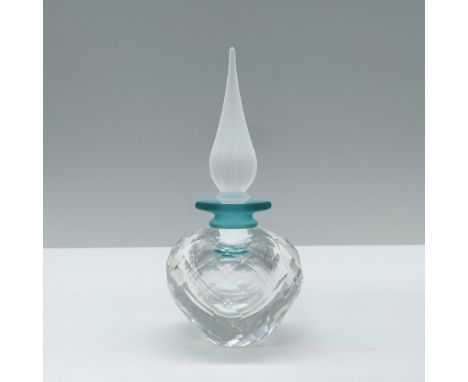 A flacon with a clear, diamond-cut body, accented with a teal ring, and topped with a large, frosted flame like topper. Swaro