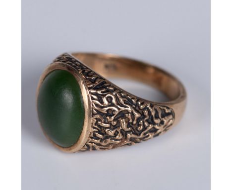 Textured yellow gold band set with a bold green stone. The ring is marked 10k and SA inside. Size 10. Dimensions: See Descrip