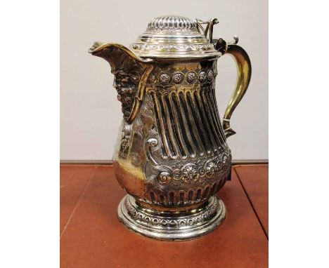 LARGE VICTORIAN SILVER PLATED LIDDED EWERthe spout with male head, with floral motifs in relief, parcel gilt interior, gilt t
