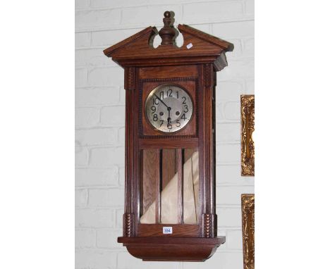 Oak cased wall clock with silvered dial.