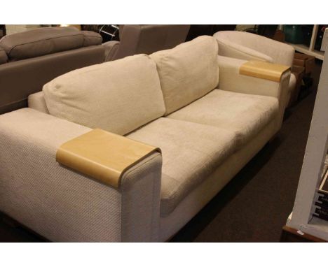 Fawn draylon two-seater settee with light wood arm protectors and matching tub chair.