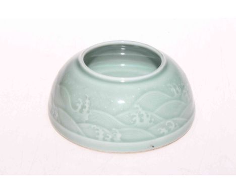 Chinese green celadon brush washer with sea scroll decoration, impressed mark, 11cm diameter.