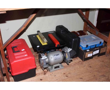 Collection of tools including bench grinder, table saw, etc.